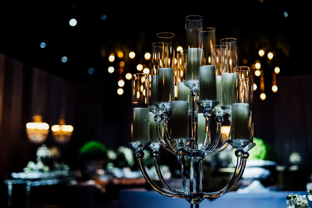 Luxury table settings for fine dining with and glassware, pouring wine to glass. Beautiful blurred background. Preparation for holiday wedding. Fancy luxury restaurant.